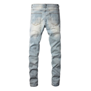 Close-up of slim fit jeans showing back pockets and distressed wash details on denim fabric