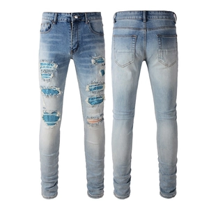Men's slim fit distressed blue denim jeans with unique polka dot patch details