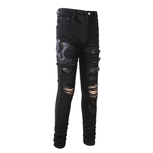 Slim fit black distressed jeans for men featuring snake embroidery and ripped detailing