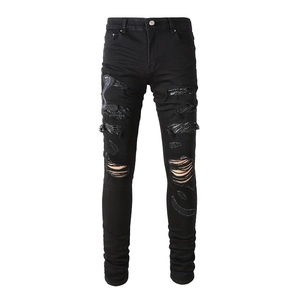 Men's slim fit black ripped jeans with detailed snake embroidery and distressed details