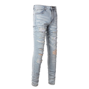 Detail of light blue distressed jeans with silver sequins inside the ripped sections