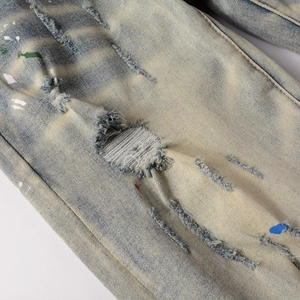 Men's retro slim distressed denim jeans with colorful paint splatters and ripped details