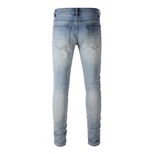Slim fit light blue distressed men's denim jeans with classic back pockets and stacked hem
