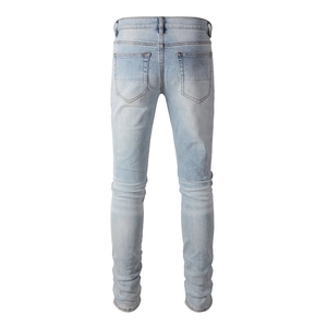 Rear view of light blue distressed slim fit denim jeans with washed texture and back pockets