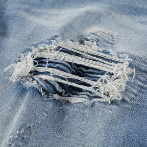Men's American high street ripped jeans with light blue wash and distressed patch details