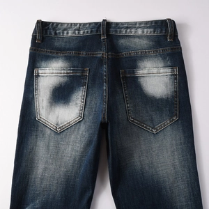 Vista dettagliata del retro di jeans in denim blu scuro lavato con tasche posteriori