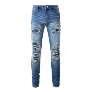 Slim fit light blue distressed jeans for men with ripped holes and PU patch details