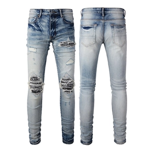 Slim fit light blue men's distressed jeans with bandana patchwork and stacked leg design