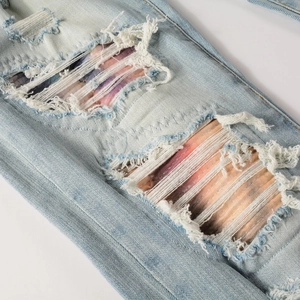 Slim fit men's gradient jeans featuring distressed ripped details with colorful striped lining