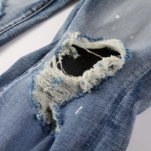 Men's slim stretch denim jeans with American style palm tree print and paint splatter