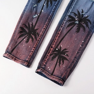 Men's distressed jeans featuring gradient wash with palm tree prints and paint splatters