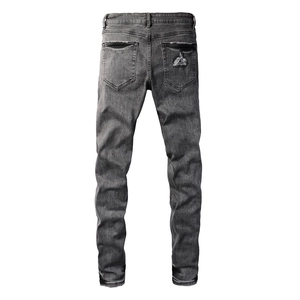 Detail view of vintage dark grey slim fit jeans with distressed pocket and washed denim