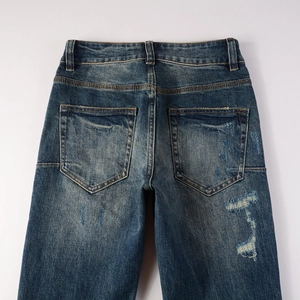 Detailed close-up of retro dark blue jeans with distressed textures and washed finish