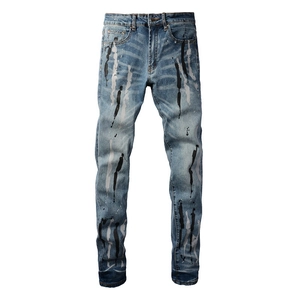 Jeans slim da uomo blu lavato con design a schizzi di vernice bianca e nera