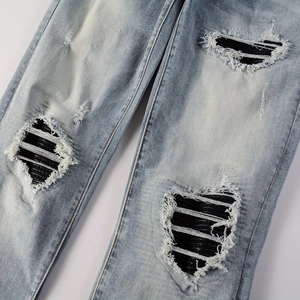 Men's light blue distressed jeans with ripped knees and striped fabric lining detail