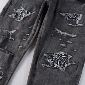 Slim fit dark gray distressed denim jeans with paisley patchwork and ripped details