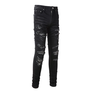 Men's slim fit black biker jeans with distressed holes and paisley patchwork details