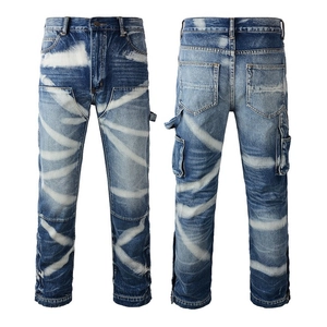 Detail view of cargo jeans featuring distressed denim fabric and unique white paint splatters