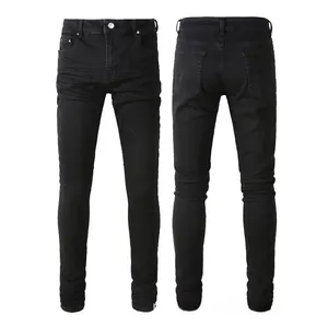 Macro detail of men's slim fit black denim jeans showing fabric texture and hem stacking