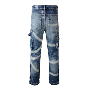 Detail view of cargo jeans with vintage wash and bold white diagonal stripe print