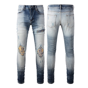 Men's slim fit distressed jeans with vintage gradient wash and patchwork rip details