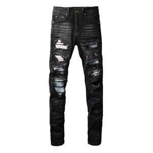 Men's slim fit black ripped jeans with colorful paisley patches and washed detailing