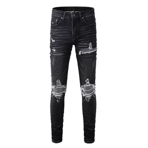 Men's slim fit black distressed jeans with rhinestone patches and street style rips