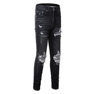 Men's slim fit black distressed jeans with rhinestone patches and street style holes