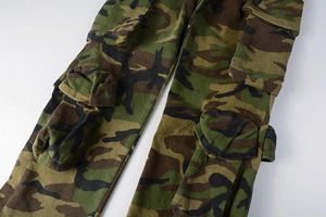 Close-up of military jungle camo cargo pants featuring multi-pocket utility design