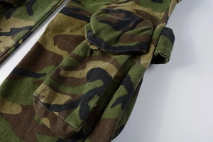 Detailed close-up of jungle camouflage cargo pants featuring a large 3D side pocket