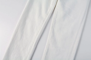 Detail view of white twill denim fabric showing neat inner seams and texture quality