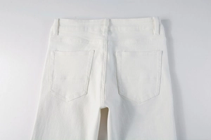 Detail view of the back waist and pockets on minimalist white slim-fit men's trousers