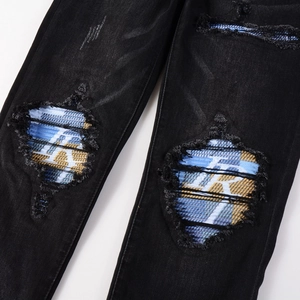 Men's black distressed slim fit jeans featuring patchwork plaid lining and R letter detail