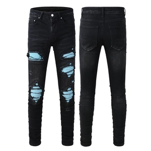 Slim fit black distressed jeans for men with blue striped patchwork and ripped details