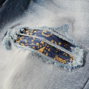 Men's retro slim-fit stretch denim jeans with patchwork ripped detailing and blue print