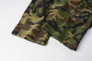 Detail view of army green camo cargo pants with durable stitching and functional side pockets