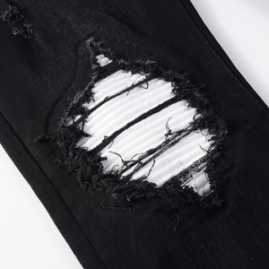 Slim fit black distressed denim jeans for men with white ribbed knee patch detail