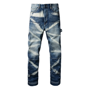 Men's vintage distressed carpenter jeans with utility pockets and white spray-paint wash