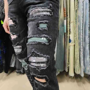 Streetwear slim fit charcoal jeans featuring colorful striped patches and distressed ripped knees