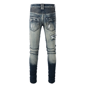 Detail view of retro blue motorcycle jeans with biker pleats and zipper pockets