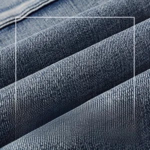 Detailed macro shot of premium blue denim fabric with twill texture and washed effect