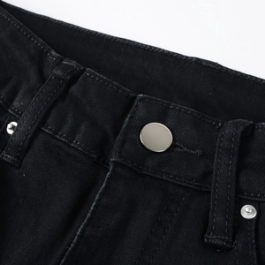 Macro shot of men's black denim jeans showing metal button and reinforced stitching detail
