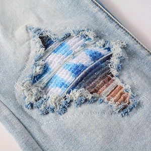 Men's American retro blue jeans featuring unique star-shaped distressed ripped patch details