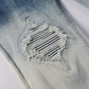 Men's high street vintage distressed jeans featuring reinforced ripped knee detail in light blue