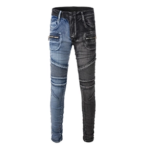 Detail of biker jeans featuring color-block patchwork and pleated moto knee panels