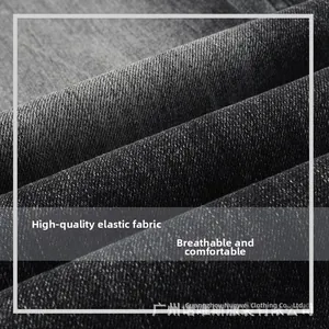 Detail of high-stretch breathable dark grey denim fabric with visible twill texture