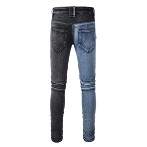 Detail view of biker jeans featuring ribbed accordion panels and two-tone denim construction