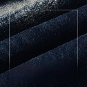 Macro shot of high-quality dark blue denim fabric showing clear diagonal twill texture
