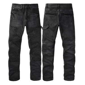 Detail of dark wash jeans showing silver rivets on knees and stone-washed fabric texture