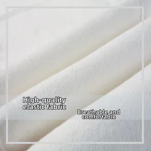 Close-up of white stretch denim fabric showing premium breathable texture and soft weave